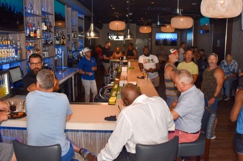 Guests gathered around the bar at Hunters in Wilton Manors.