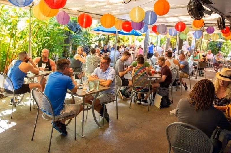 Guests beneath colorful lanterns on the patio at Rosie’s Bar & Grill.