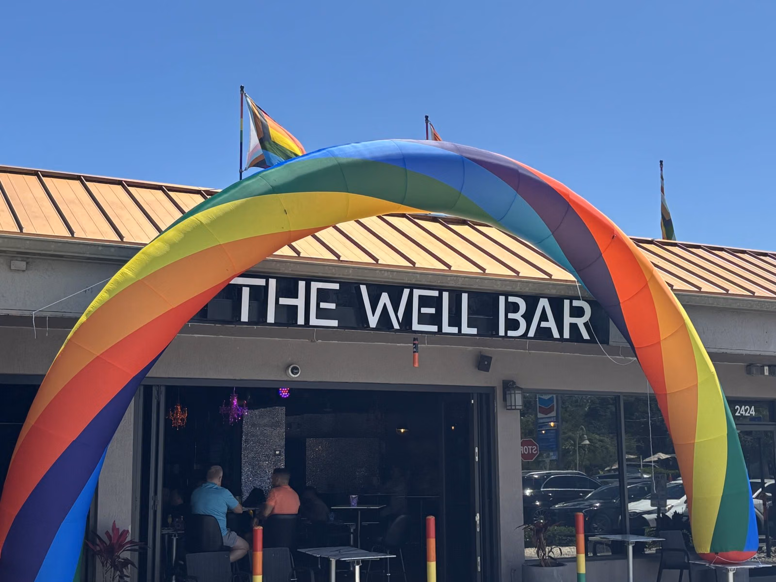 A rainbow arch over the entrance to The Well Bar in Wilton Manors.