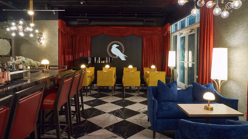 Checkerboard floor, red curtains and lounge seating inside West End Lounge in Wilton Manors.