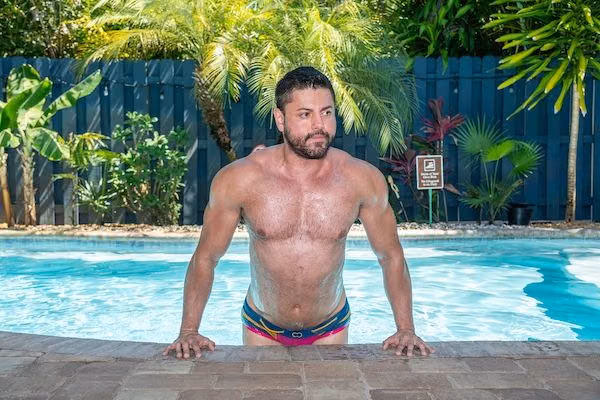 A man at the edge of Fantasy Island Inn’s outdoor pool.