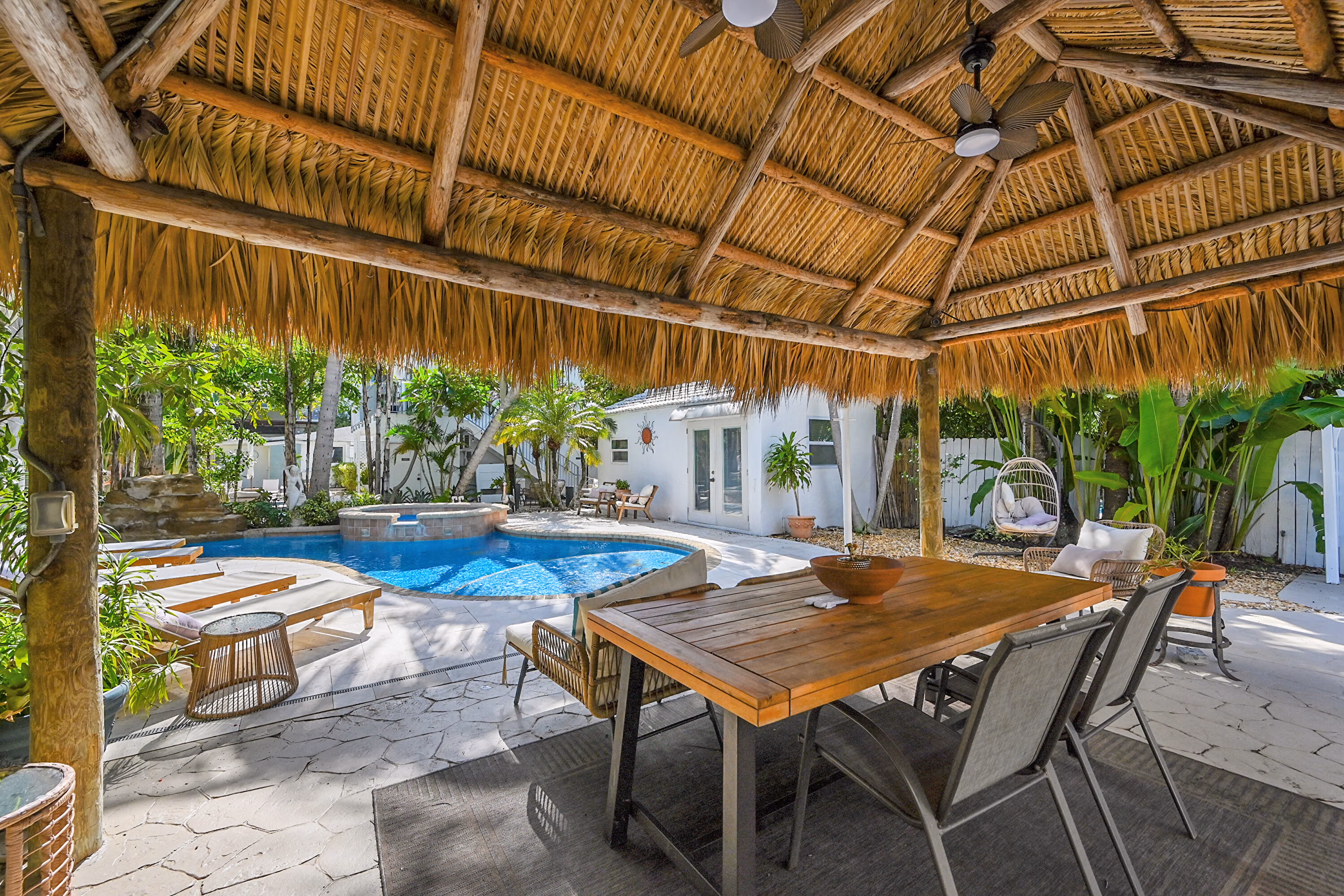 Thatched outdoor dining area overlooking the pool at Inn on the Drive.