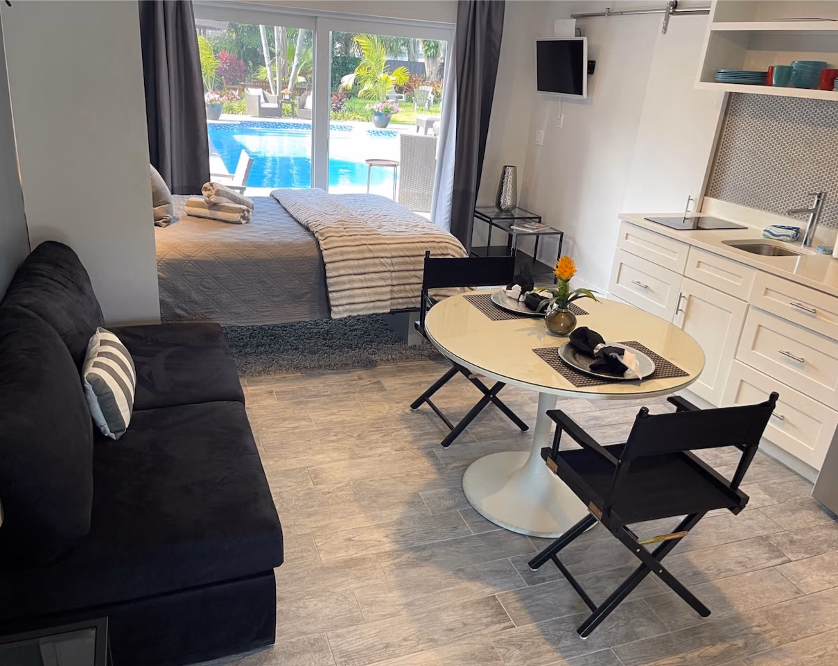 The Cabana House room with kitchen facilities and doors overlooking the pool at Solstice.