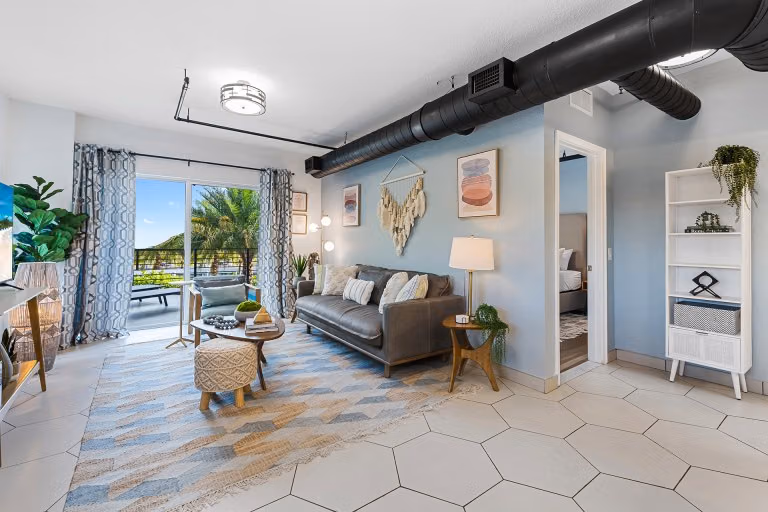 Living room and balcony in a one-bedroom apartment at Wilton River Suites.