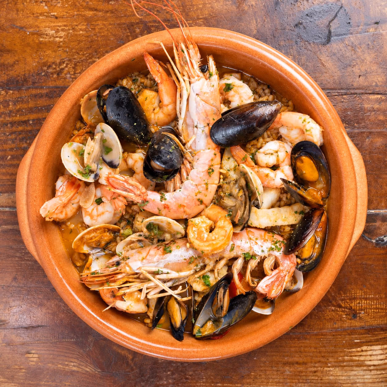 AI recreation of a seafood paella from Candela Restaurant.