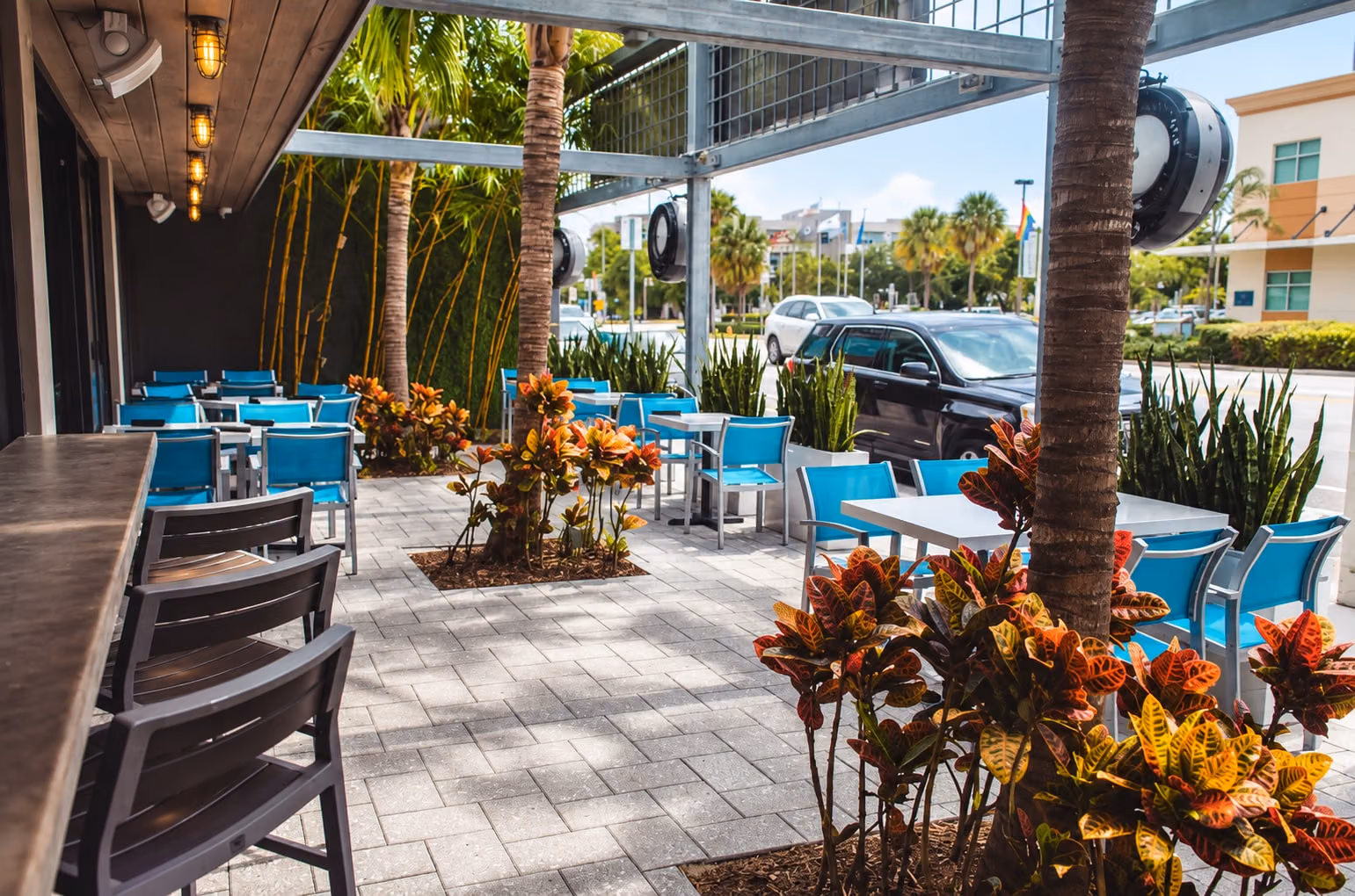 AI recreation of turquoise chairs and tables on the ethos Greek Bistro patio.