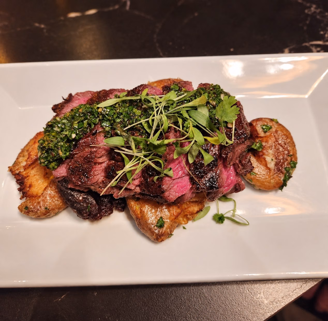 AI recreation of steak with chimichurri and potatoes at PROOF.