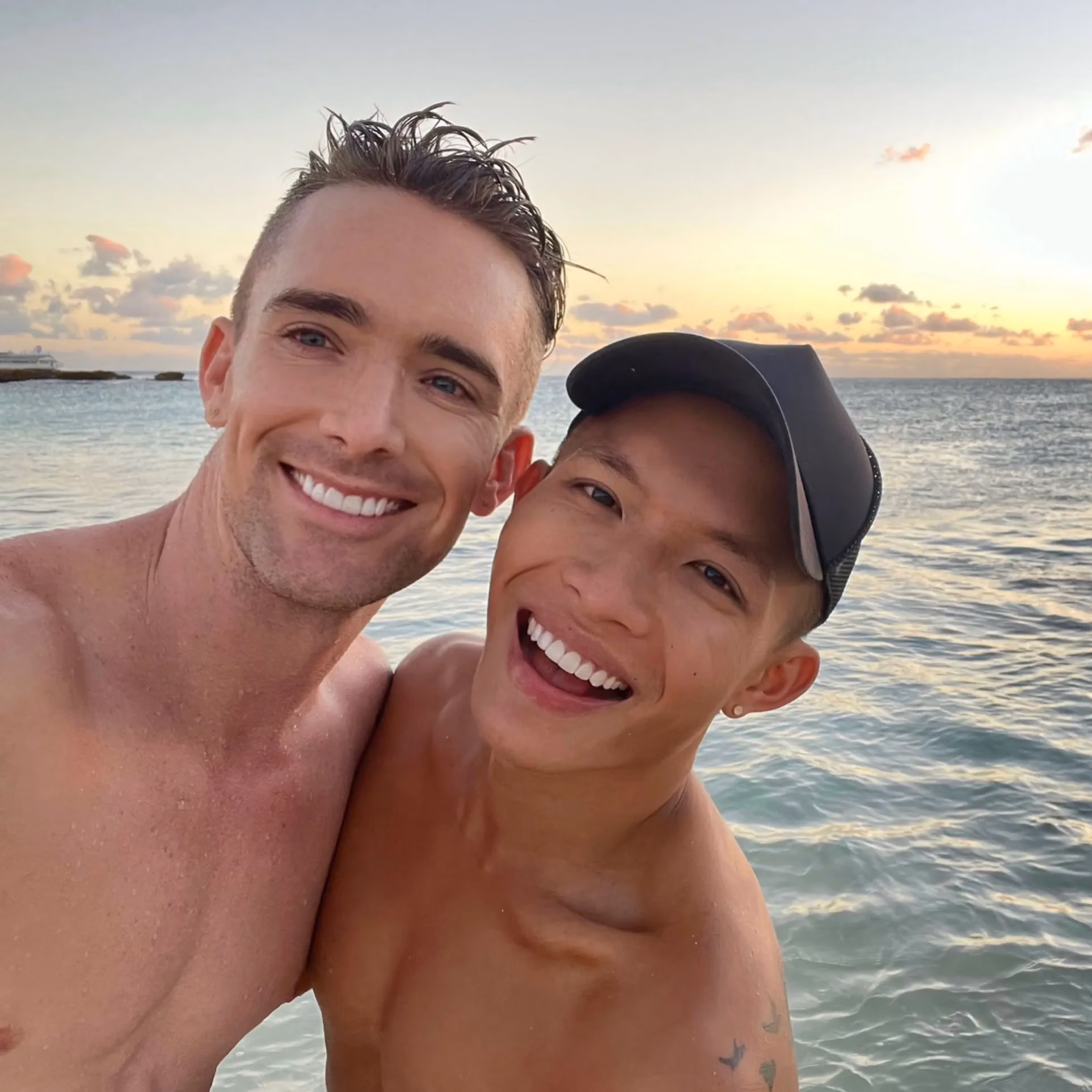 Two people smiling together at the beach